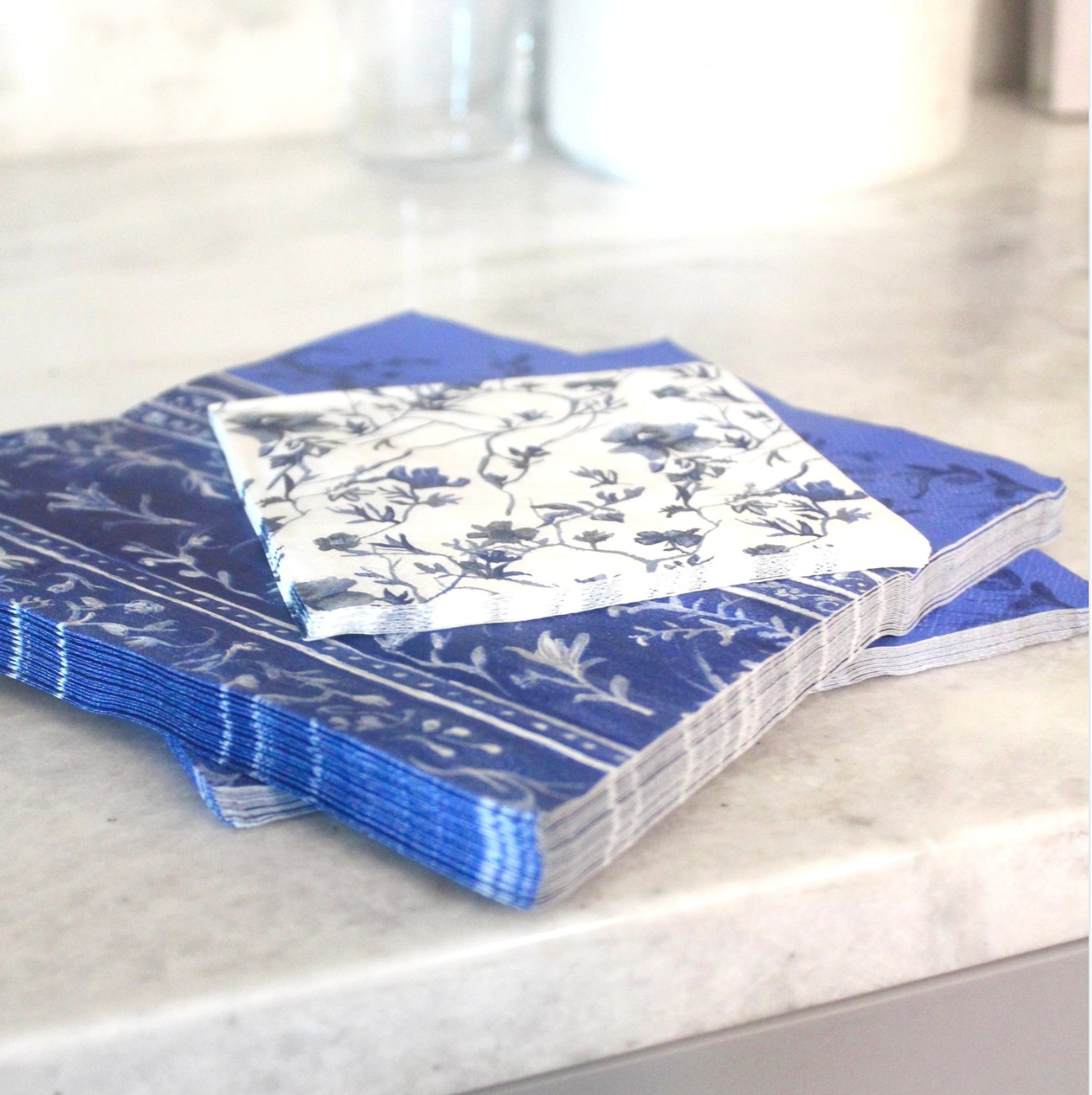 Blue dinner napkins and floral beverage napkins, perfect for hosting 